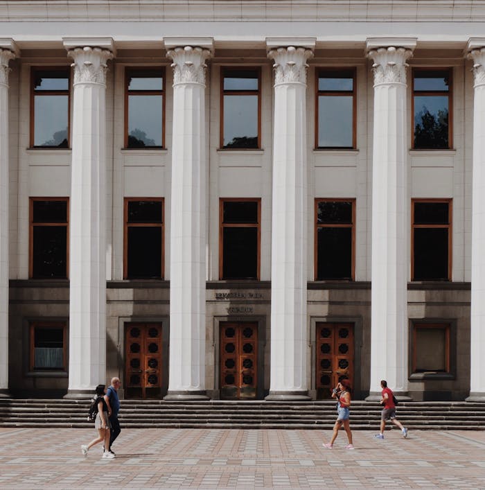 Elegant exterior of Ukraine's parliament building in Kiev with classical columns and pedestrians.
